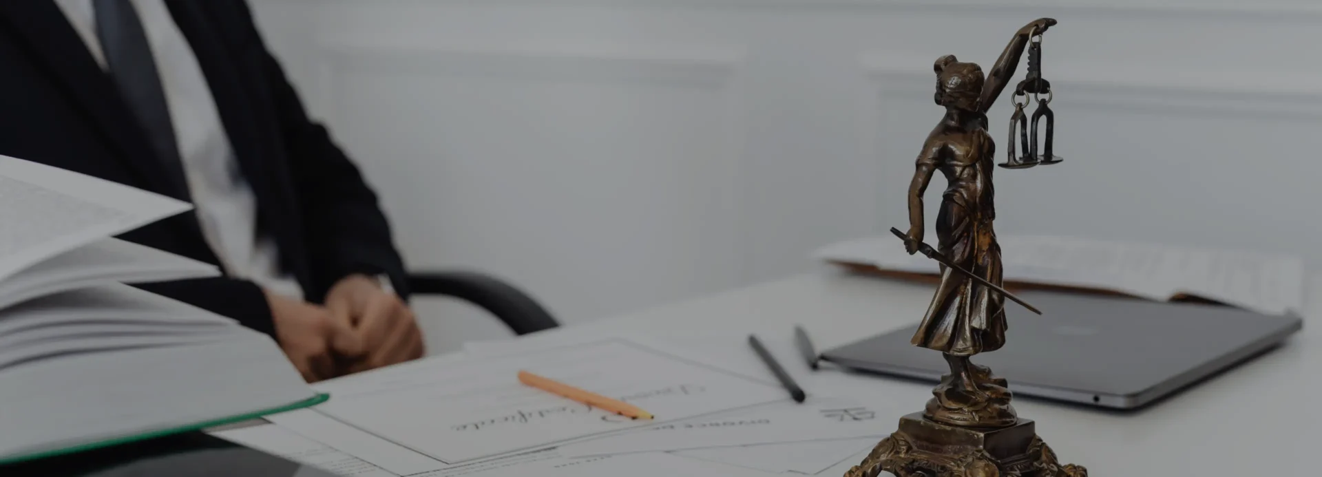 A person sitting at a table with papers and pencils.